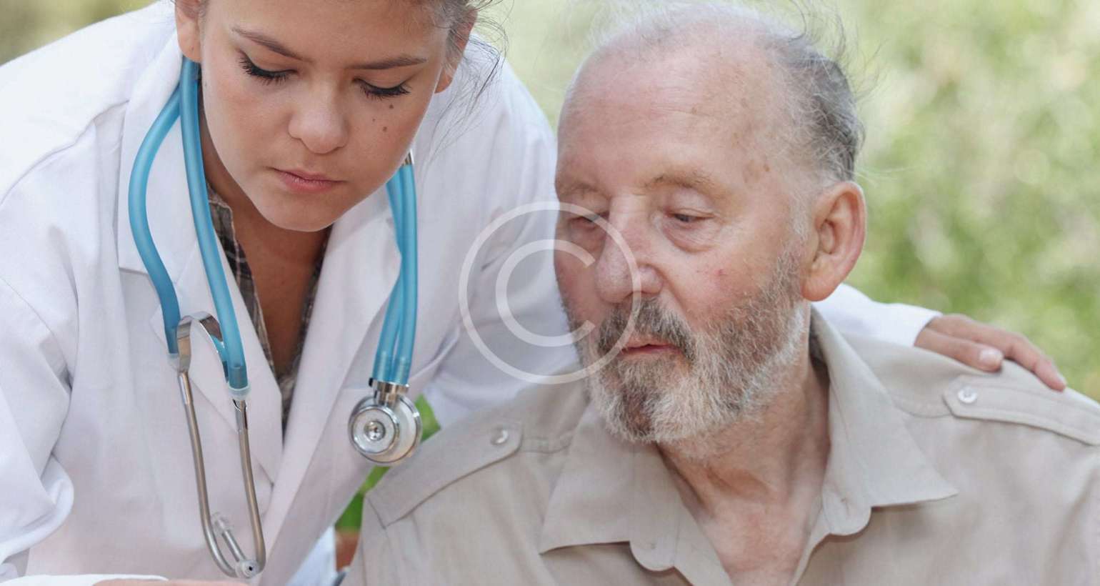 Doctor checking temperature of an elderly man.